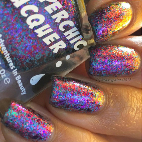 Quickening Nail Polish, close-up view of nails painted with holographic, multi-colored glitter nail polish.