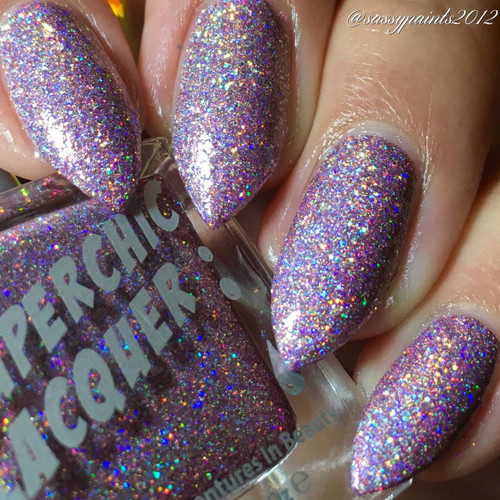 Skin Tight Nail Polish, close-up of nails coated with holographic, glittery purple nail polish.