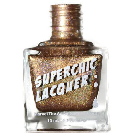 Dart Thru The Heart Nail Polish, glittery gold nail polish in a clear square bottle with a metallic gold cap.