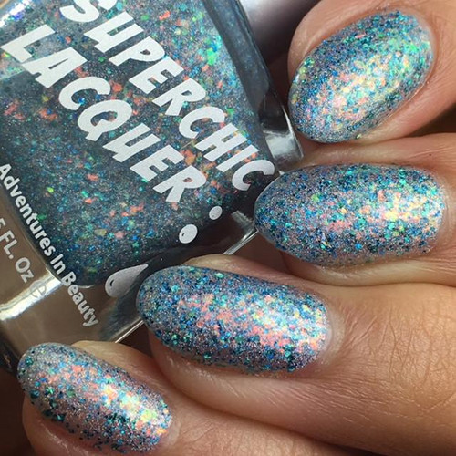 Crazy On You Nail Polish, close-up of fingernails painted with glitter multicolor nail polish.