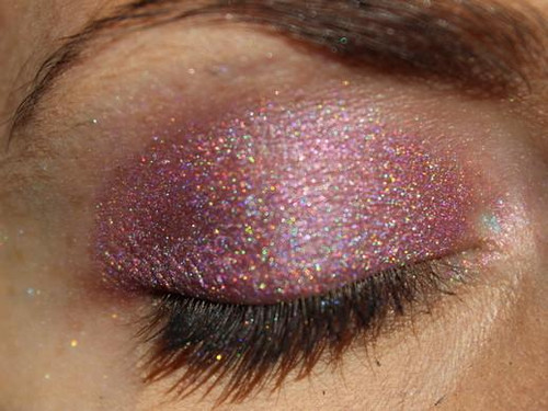 Pinky Promise Holographic Eyeshadow, close-up of a closed eye showcasing pink holographic glittery eyeshadow with shimmering effects.