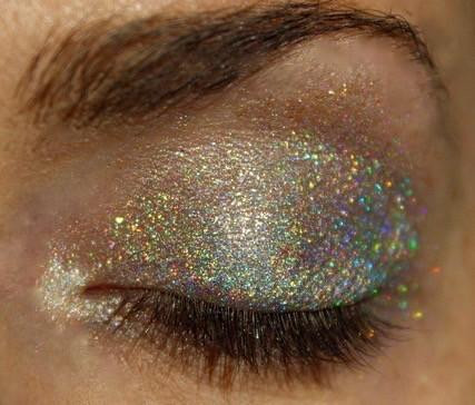 Chasing Unicorns Holographic Eyeshadow, close-up of a closed eye with shimmering holographic glitter makeup on the eyelid.