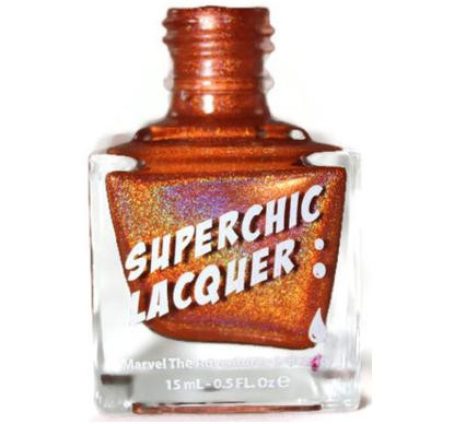 Juicy Nail Polish, holographic copper-colored nail lacquer in a clear glass bottle with white and orange label.