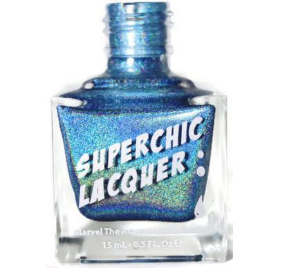 Spill It Nail Polish, blue holographic nail polish in a glass bottle with a blue cap and label displaying the product name.