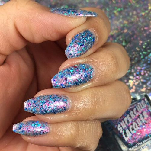 Don't Eat The Cotton Candy Nail Polish, close-up of a hand with nails painted in a glittery, multicolored cotton candy theme.