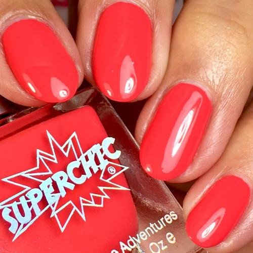 Fireball Nail Polish, vibrant coral-orange nail polish on fingernails with a glossy finish.