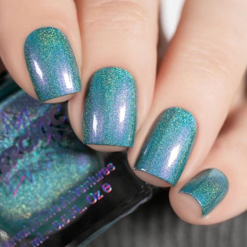 Endora Nail Polish, holographic blue-green shimmering nail polish on neatly manicured fingernails.