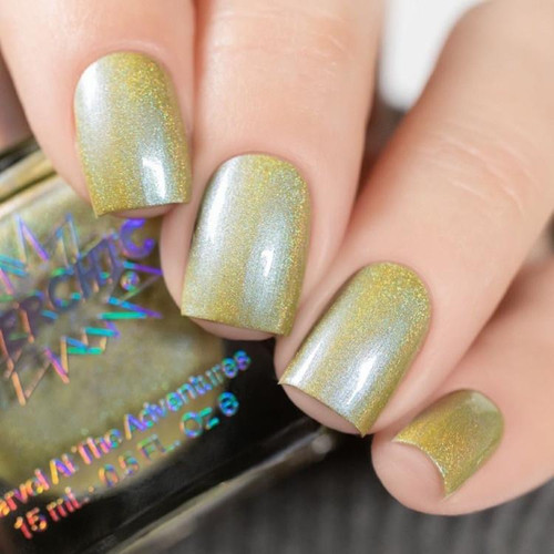 Gladys Kravitz Nail Polish, close-up of fingernails painted with shimmery, holographic pastel yellow-green nail polish.