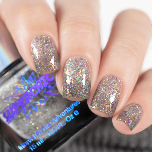 Incantation Nail Polish, sparkling holographic glitter nail polish on fingers.