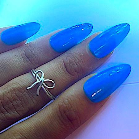 Hot Spot Neon Shimmer Nail Polish, vibrant blue nail polish on long, oval-shaped nails with a glossy finish
