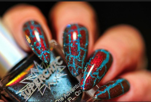 Harlequin NutCrackle Nail Polish - Multichrome Crackle Effects, multicolored crackle nail polish on fingernails with blue and red shades and a shiny finish.