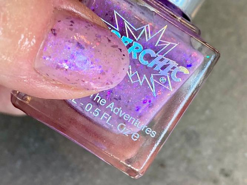 Phobia Purple Jelly Nail Polish - Inside Out Emotions Themed Nail Paint, close-up of a hand holding a bottle with purple holographic jelly nail polish.