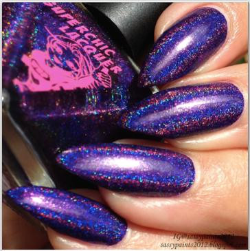 40 Winks Nail Polish, close-up of beautifully painted nails with vibrant purple and blue holographic glitter polish.