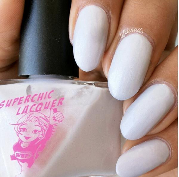 Nothing Ventured Nail Polish, hand with painted white nails.