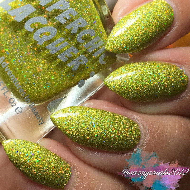 Make It Work Nail Polish, close-up of nails painted with vibrant yellow-green glittery nail polish containing multicolored holographic sparkles.