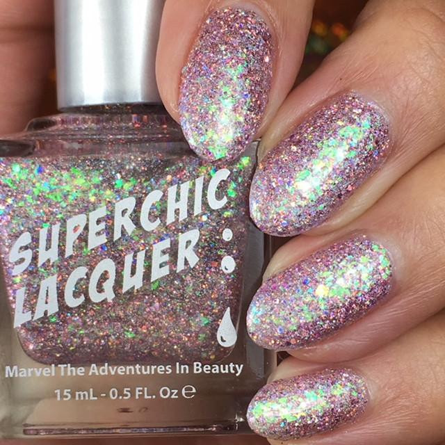Love Stinks Nail Polish, glittery holographic nail polish on fingernails with a sparkling finish.