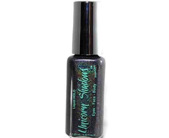Mystic Ride Holographic Eyeshadow, holographic liquid eyeshadow with a sparkly, iridescent finish in a small bottle with a silver cap.