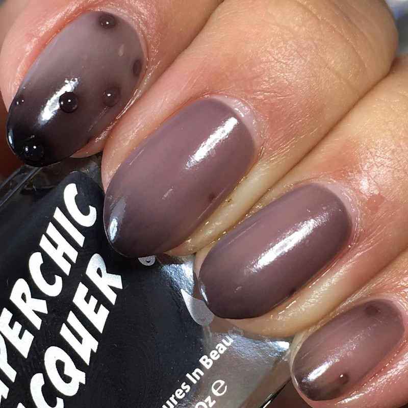 Empowered Thermal Nail Polish, glossy mauve and black nail design on fingers.