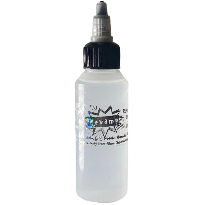 Nail Polish Thinner - REVAMP Lacquer Restoration Drops, clear plastic bottle with a black and gray spray nozzle cap and a label that reads 'revamp' for nail polish restoration.
