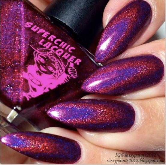 Wake Me Up Nail Polish, vibrant purple and pink holographic nail polish on long, shaped nails.