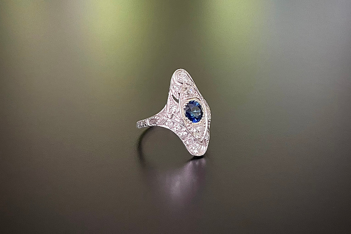 A wonderful Sapphire and Diamond Plaque Ring
Pierced navette shaped.
Centrally set with a round sapphire.
Set throughout with old cut diamonds.
Sapphire weight: 0.93cts
Total diamond weight: 
Platinum.
Total weight: 4.16gms