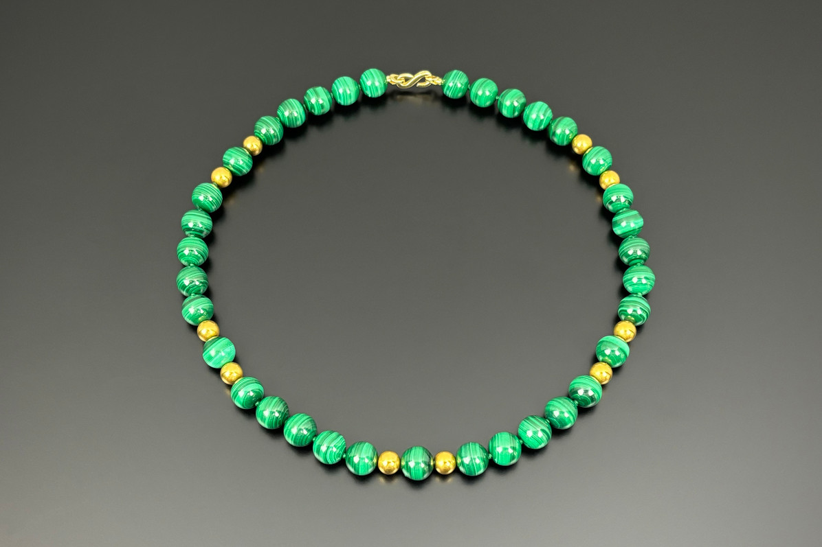 A Strand of Malachite and Gold Beads
