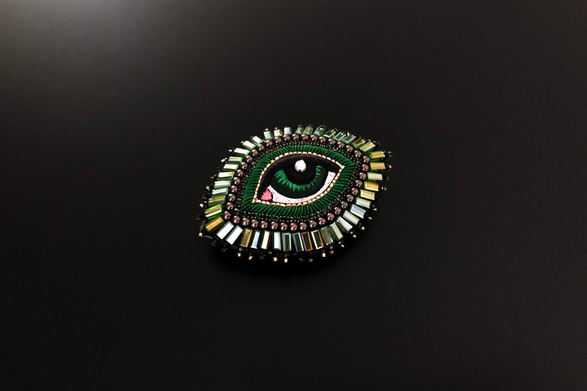Green eye brooch with silk and beads by Celeste Mogador.