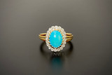 A Beautiful Turquoise and Diamond Ring
Cluster form, oval turquoise cut en cabochon measuring 10 x 7.5mm
Surrounded by twenty old cut diamonds
Upswept reeded band
18ct gold
Total weight: 5.08gms
Diamond weight: 0.20cts total
Colour: H-I
Clarity: SI-P