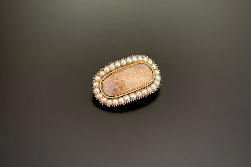 An Elegant Gold and Pearl Mourning Brooch
Domed oval form
Central oval glazed panel with woven hair
Having a border of natural pearls in crimped settings
Rolled gold
Engraved to reverse “ …Daxby, Ob 3rd Aug 1804 … 32 