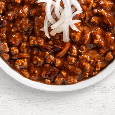 A nod to the Queen City's most iconic dish, our Cincinnati Style Sweet Chili brings a comforting twist to traditional chili with its warm blend of cinnamon and unsweetened chocolate—a secret combination that creates its signature deep flavor and rich color.