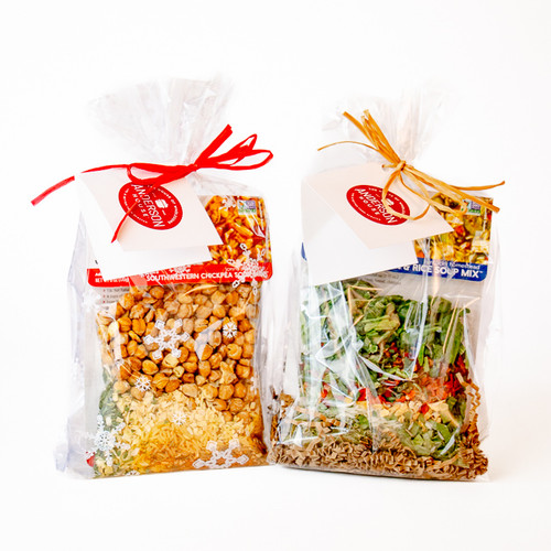 Perfect Pair Gift Box featuring both cello bag options side by side—one with a festive snowflake design and one in a simple, classic clear wrap—each holding a soup mix and cornbread pairing Perfect Pair Gift Box featuring both cello bag options side by side—one with a festive snowflake design and one in a simple, classic clear wrap—each holding a soup mix and cornbread pairing