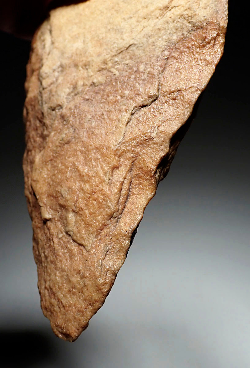 EXCEPTIONAL TRIANGULAR ACHEULEAN HAND AXE IN RED SANDSTONE MADE BY