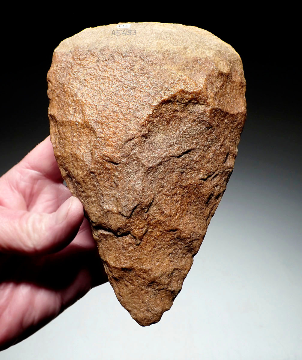 EXCEPTIONAL TRIANGULAR ACHEULEAN HAND AXE IN RED SANDSTONE MADE BY