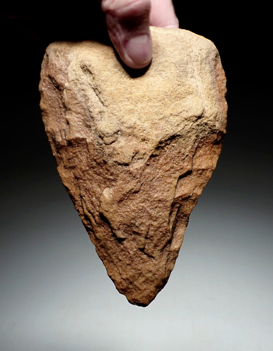 EXCEPTIONAL TRIANGULAR ACHEULEAN HAND AXE IN RED SANDSTONE MADE BY