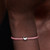 Modelo luciendo el Charm Pandora Mini Mariposa en plata de ley sobre una pulsera de cordón rosa - 794519C00