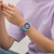 Modelo luciendo el Reloj Swatch Swatch Neon Hielo con esfera violeta y brazalete de silicona azul - SB01K400