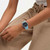 Vista lateral en muñeca del Reloj Swatch Blue Moves con brazalete de silicona azul y esfera negra - SO29L101