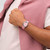 Modelo luciendo el Reloj Swatch Pink Petal Promise con esfera rosa y brazalete de piel en primer plano - YLS234