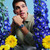 Modelo luciendo el Reloj Swatch Blue Petal Promise con correa de piel azul y esfera azul - YLS235