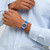 Vista en muñeca del Reloj Swatch Blue Petal Promise con correa de piel azul y esfera azul - YLS235