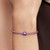 Modelo luciendo el Charm Mini Pieza de Puzle Morada de Pandora en plata de ley y esmalte morado en una pulsera de cordón - 794816C02