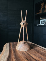 Hand-carved Suar wood sculpture with a domed base, slender legs, and a central circular opening.