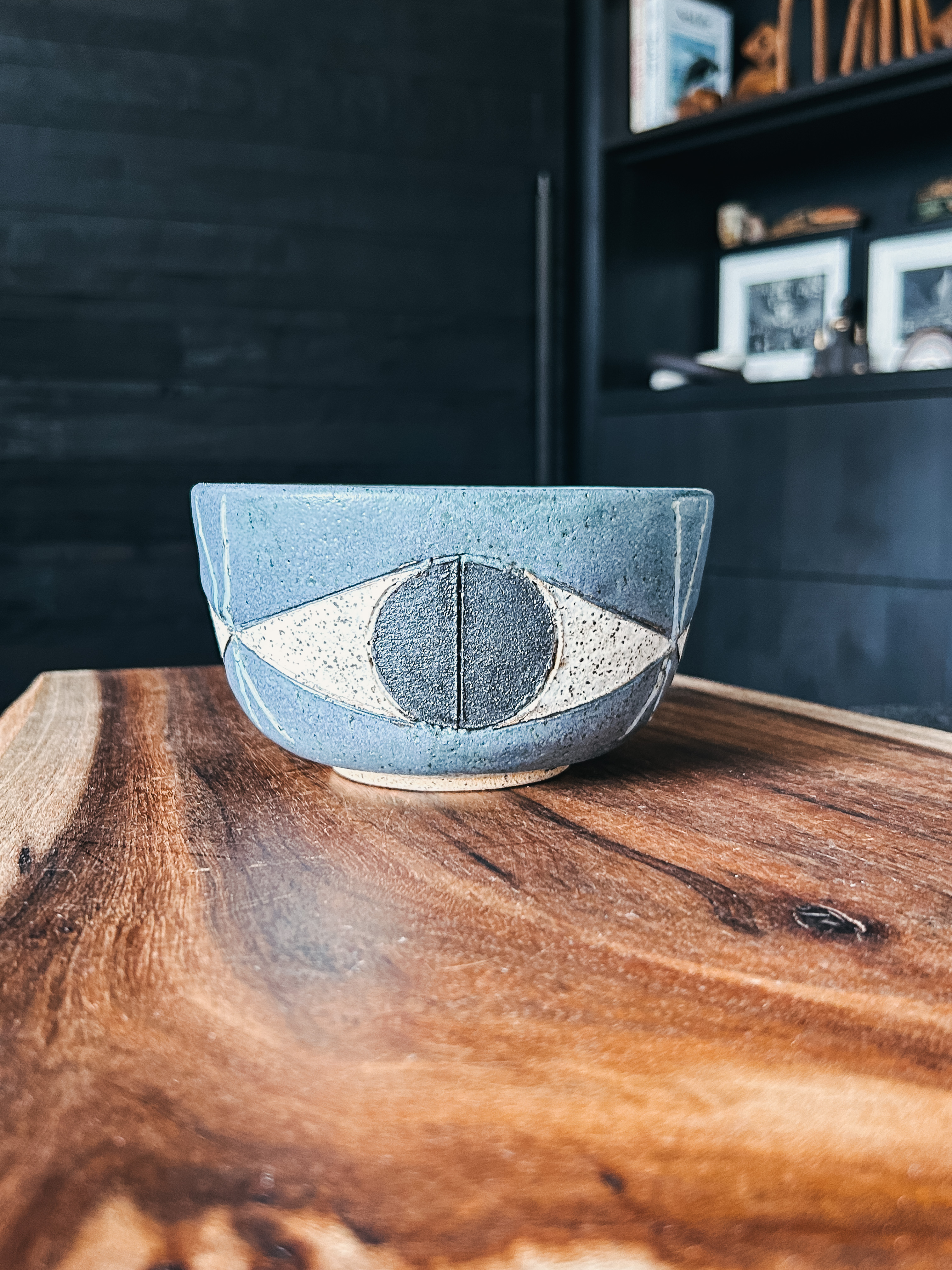 A handcrafted bowl featuring an artistic eye motif by Matthew Ward.