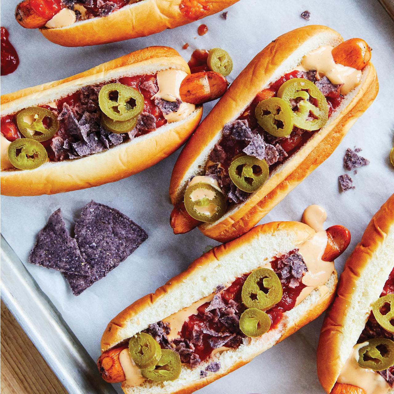 hotdog sandwiches topped with jalapeno and crushed chips