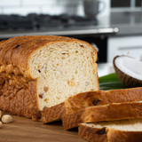 Fresh loaf of King's Hawaiian Coconut Macadamia Nut Sliced Bread 1lb, baked with real Hawaiian Macadamia nuts and premium coconut flakes