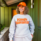 Lifestyle image of King's Hawaiian beige crewneck with puff print logo graphic, front Lifestyle image of King's Hawaiian beige crewneck with puff print logo graphic, front