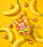 King's Hawaiian Shake 'Em Bananaaa! Bites on yellow background with bananas surrounding tub