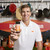 Image of Eli Manning holding King's Hawaiian Football Seasoning, 4 oz container on a kithen background