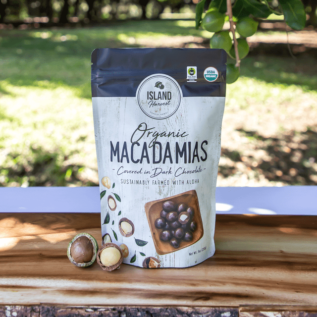 Island Harvest Organic Macadamia Nuts Covered in Dark Chocolate outdoors on wooden surface