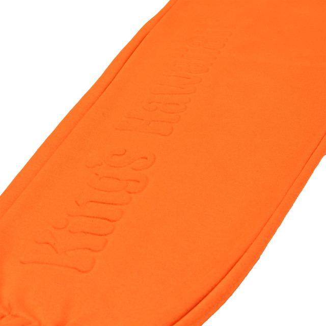King's Hawaiian orange joggers with embossed logo down the leg, close up King's Hawaiian orange joggers with embossed logo down the leg, close up